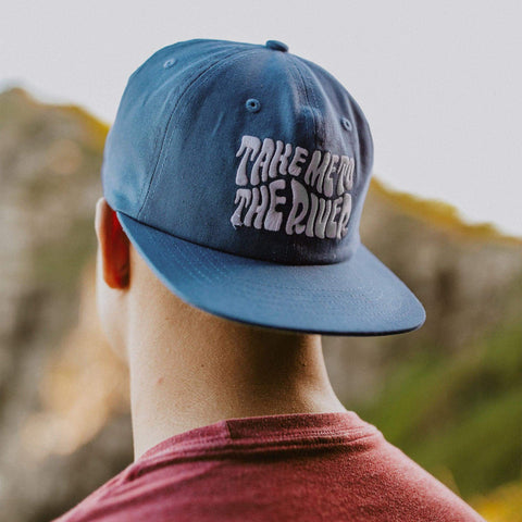 Trek Light Take Me To The River Hat on a person, perfect for outdoor adventures by the river. Stylish 6-panel snapback design.