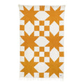 Beautiful handwoven Goldie blanket made from recycled clothing materials, featuring a cozy geometric design with versatile charm. By Trek Light.