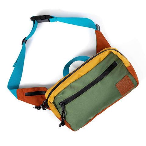 Colorful Trek Light Everyday Fanny Pack with adjustable blue strap and multiple pockets, versatile for hip or shoulder wear.