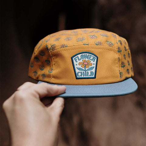 Trek Light Flower Child Kids 5-Panel Snapback Hat in mustard with floral print and blue flat brim
