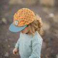 Child wearing Flower Child Kids Hat, a 5-panel snapback with flat brim in 100% cotton, promoting style and adventure by Trek Light.