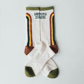 Happy To Be Here socks by Trek Light, featuring colorful stripes and green accents, designed for comfort and breathability.