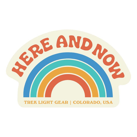 Colorful retro 'Here And Now' sticker from Trek Light Gear, 4x2.5 inches, weatherproof vinyl, UV fade-resistant for 3-5 years, made in USA.