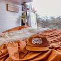 Trek Light Home Sweet Van corduroy hat in cozy van interior with mountain view, perfect for van life enthusiasts.
