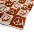 Cozy Trek Light blanket with orange peace signs, perfect for adding warmth and style to any space.