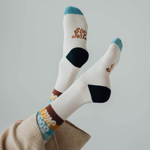 Stay Wild socks by Trek Light on feet, showcasing trendy design with perfect stretch and cushion for ultimate comfort and style.