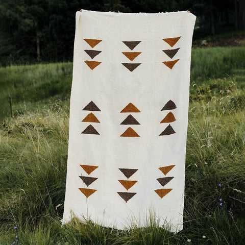Summit Blanket handwoven from recycled materials, featuring cozy, beautiful geometric design. Perfect for versatile, sustainable use. By Trek Light.