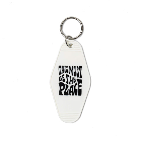 Retro-style key tag with 'This Must Be The Place' text, perfect for Trek Light adventures and nostalgic vibes.