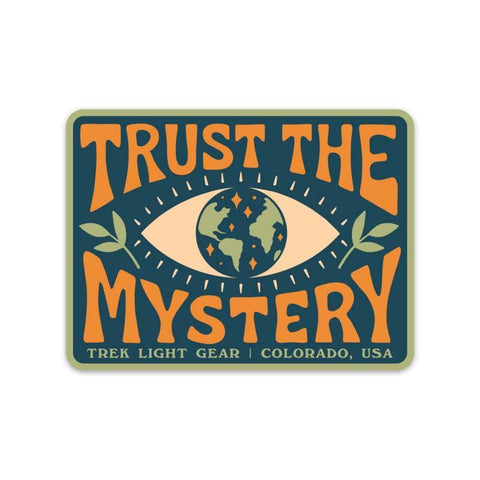 Trust The Mystery Sticker by Trek Light, featuring eye design and world map, made in USA, weatherproof and UV resistant for outdoor use.